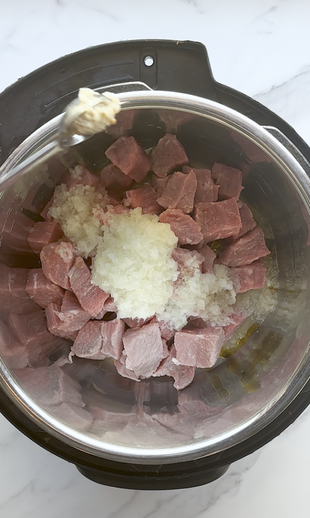 chunks of beef cut in 3 inch squares for beef korma and with onions over the top